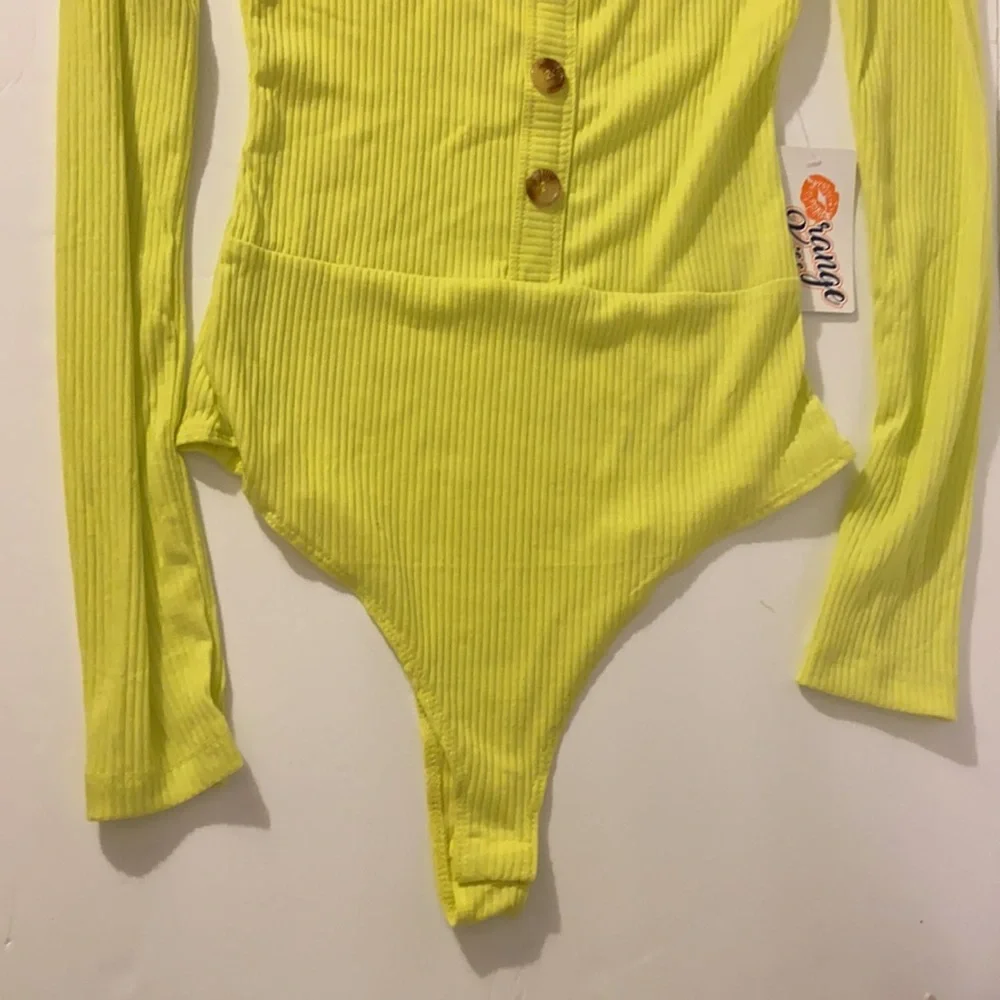 Neon yellow long sleeve sexy body suit. Size small. New with tags